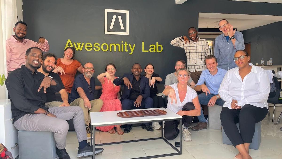 Group photo of the Awesomity Lab team and visitors in the office in Kigali.